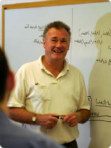 Allen Tucker standing in front of a whiteboard